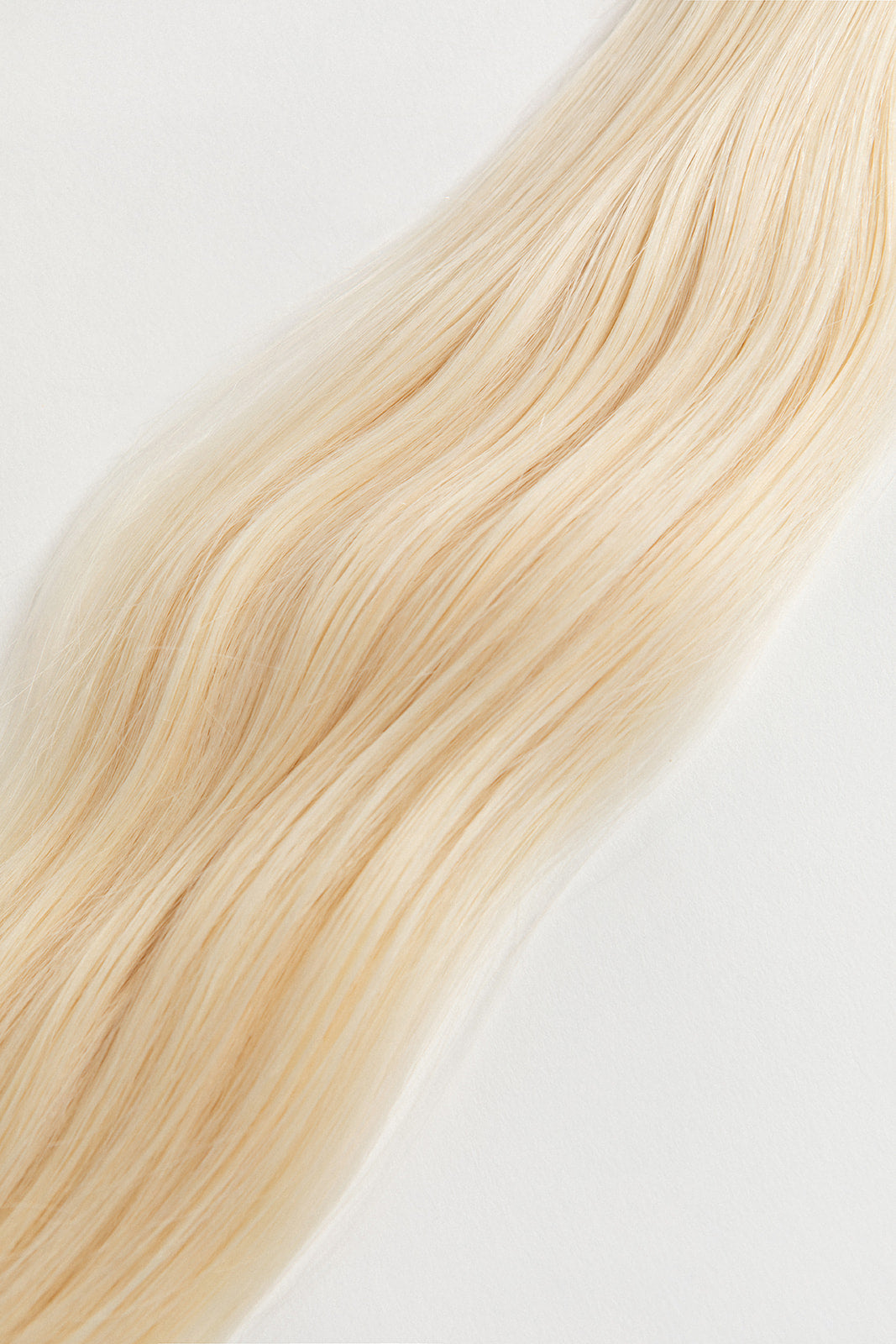Moonstone is our lightest and brightest blonde with slight golden undertones. C'mon Barbie, let's go party! Stylist lingo: Natural level 10 Harloc Tape-In Extensions are made from ethically sourced, premium, Remy Slavic Hair. These reusable hair extensions can be used to add length, volume, chemical-free colour, or to correct or enhance a haircut. Available in 16 beautiful shades. Combine multiple colours to create a custom colour blend and perfect match.