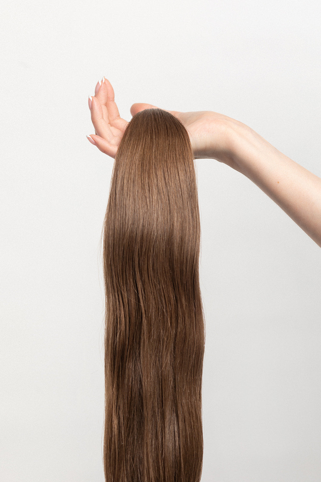 Walnut is our light brown, with cool yet rich undertones. Stylist lingo: Natural level 7 Harloc Tape-In Extensions are made from ethically sourced, premium, Remy Slavic Hair. These reusable hair extensions can be used to add length, volume, chemical-free colour, or to correct or enhance a haircut. Available in 16 beautiful shades. Combine multiple colours to create a custom colour blend and perfect match.